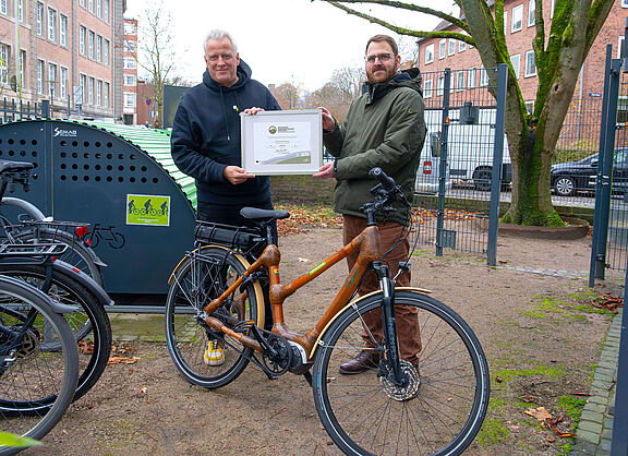 Jan Voß (ADFC SH) übergibt das Zertifikat "Fahrradfreundlicher Arbeitgeber" in Gold an Sören Mohr (Geschäftsführer New Communication) Jan Voß (ADFC SH) übergibt das Zertifikat "Fahrradfreundlicher Arbeitgeber" in Gold an Sören Mohr (Geschäftsführer New Communication)